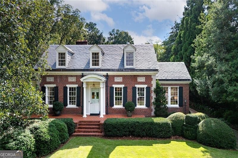 a front view of a house with garden