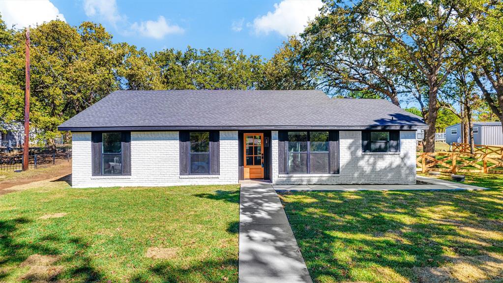 Ranch-style home featuring a front yard