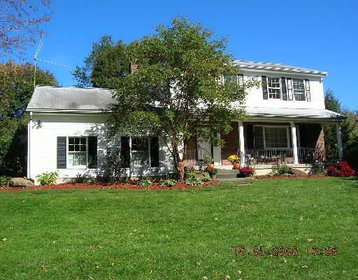 a front view of a house with garden and porch