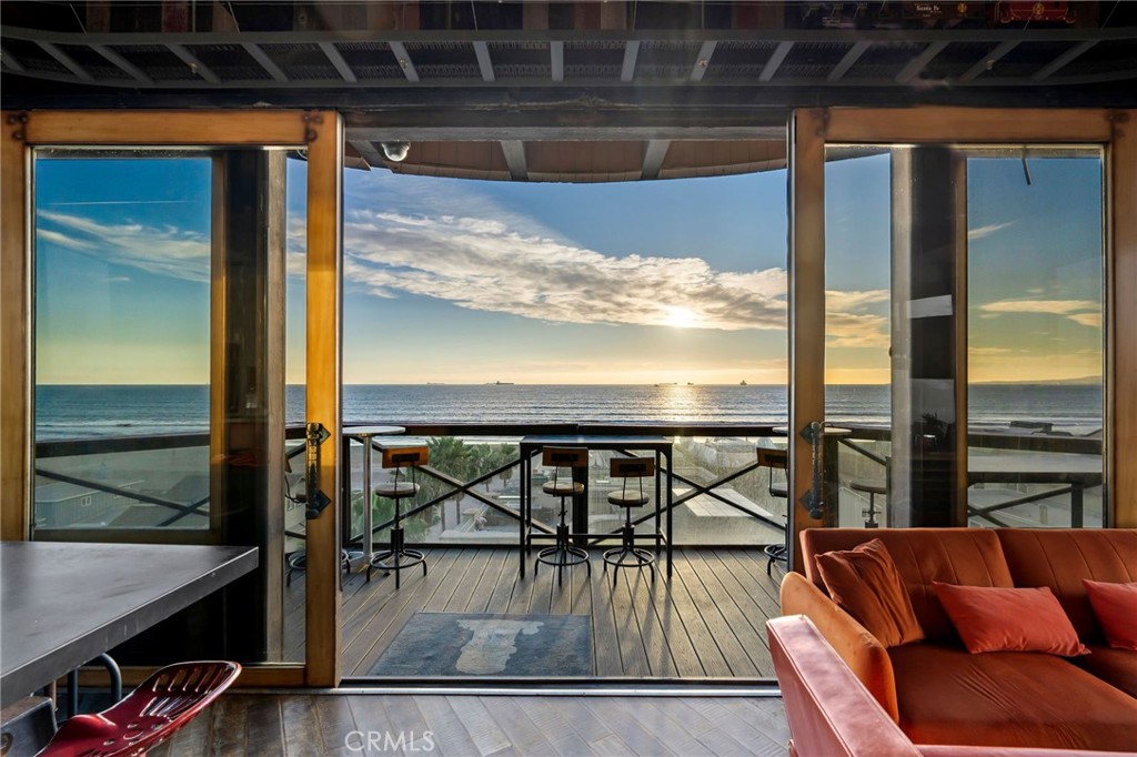 a view of a balcony with furniture and wooden floor