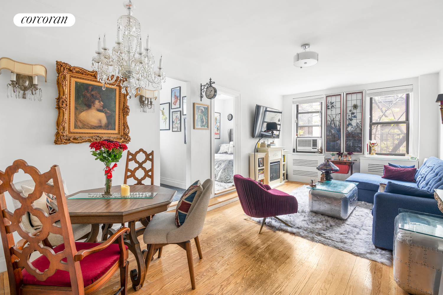 a living room with furniture and a chandelier