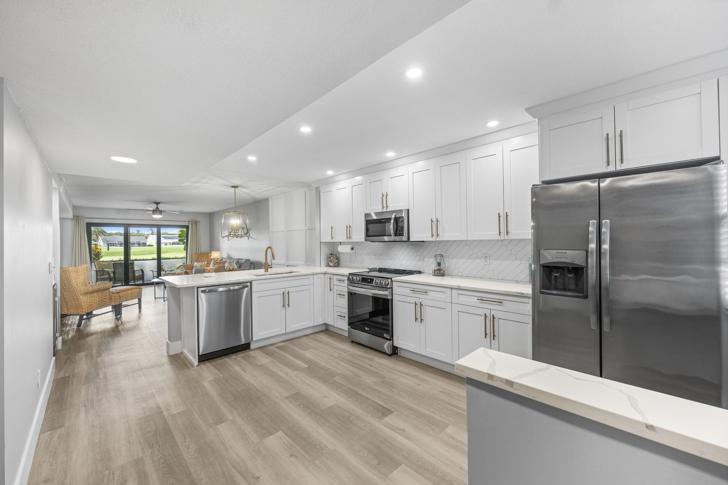 a kitchen with a refrigerator sink and cabinets