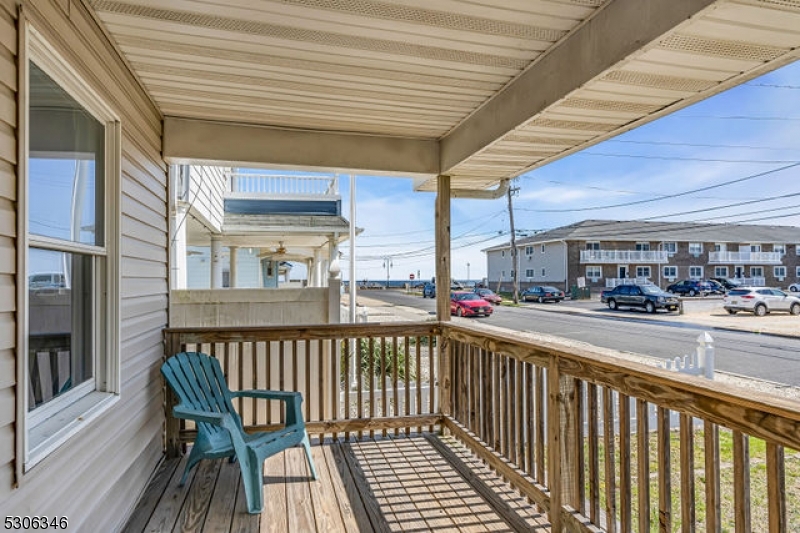 a view of a balcony and car parked