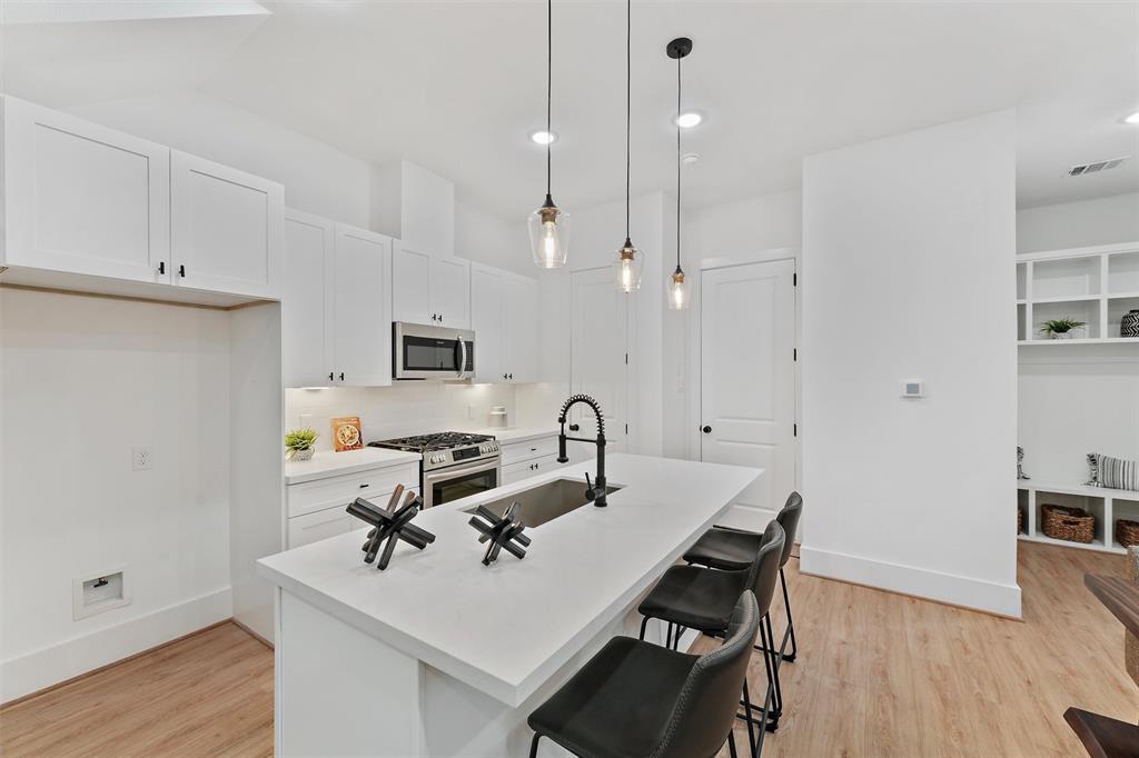 a view of a kitchen with a table and chairs