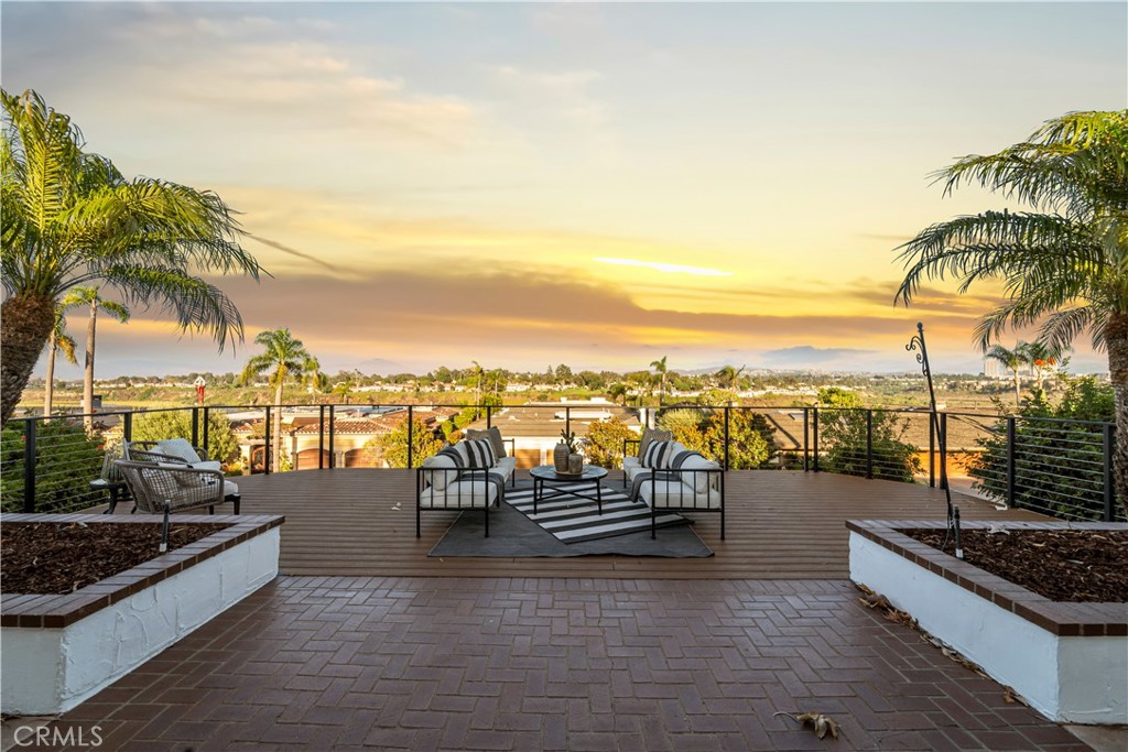 a view of a terrace with lawn chairs