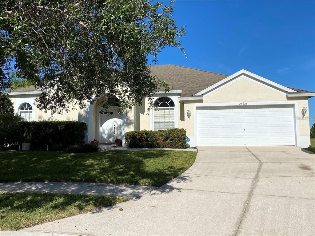 a front view of a house with a yard garage and outdoor seating