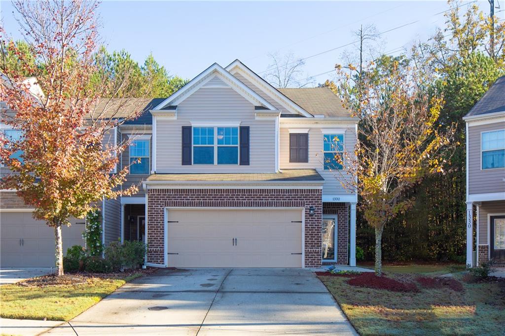 a front view of a house with a yard and garage