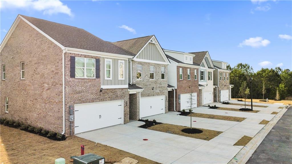 a front view of residential houses with yard