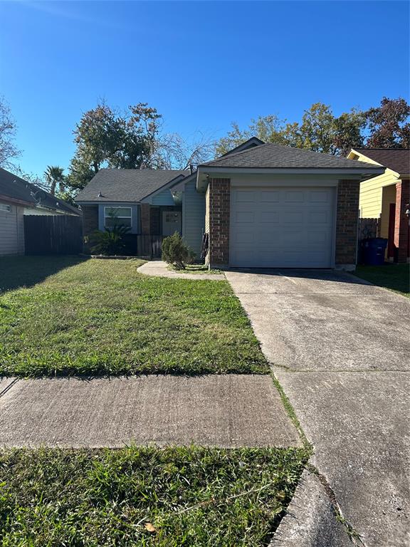 a front view of a house with a garden and yard