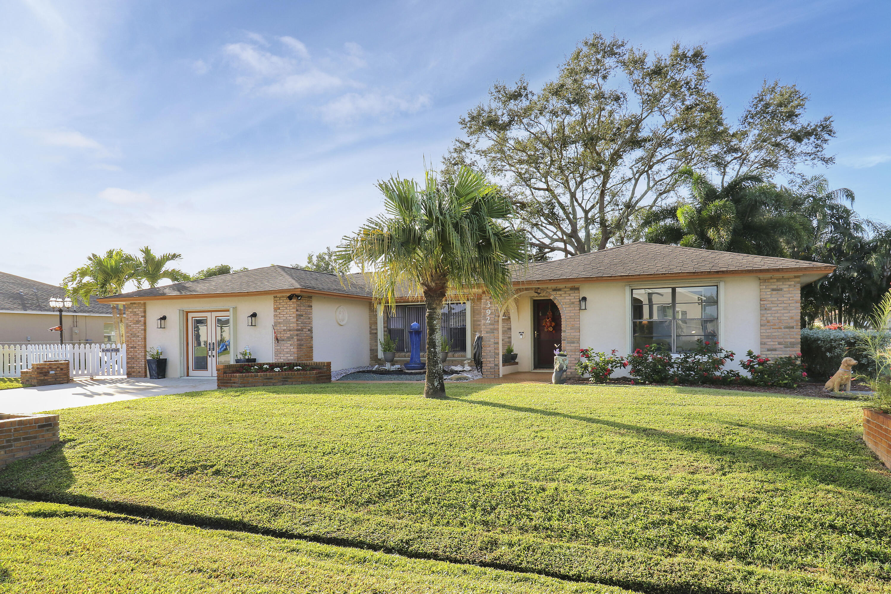 a view of a house with a yard and tree s