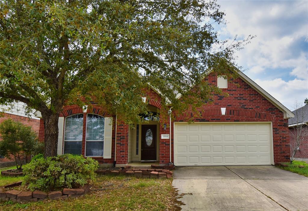 front view of a house with a tree