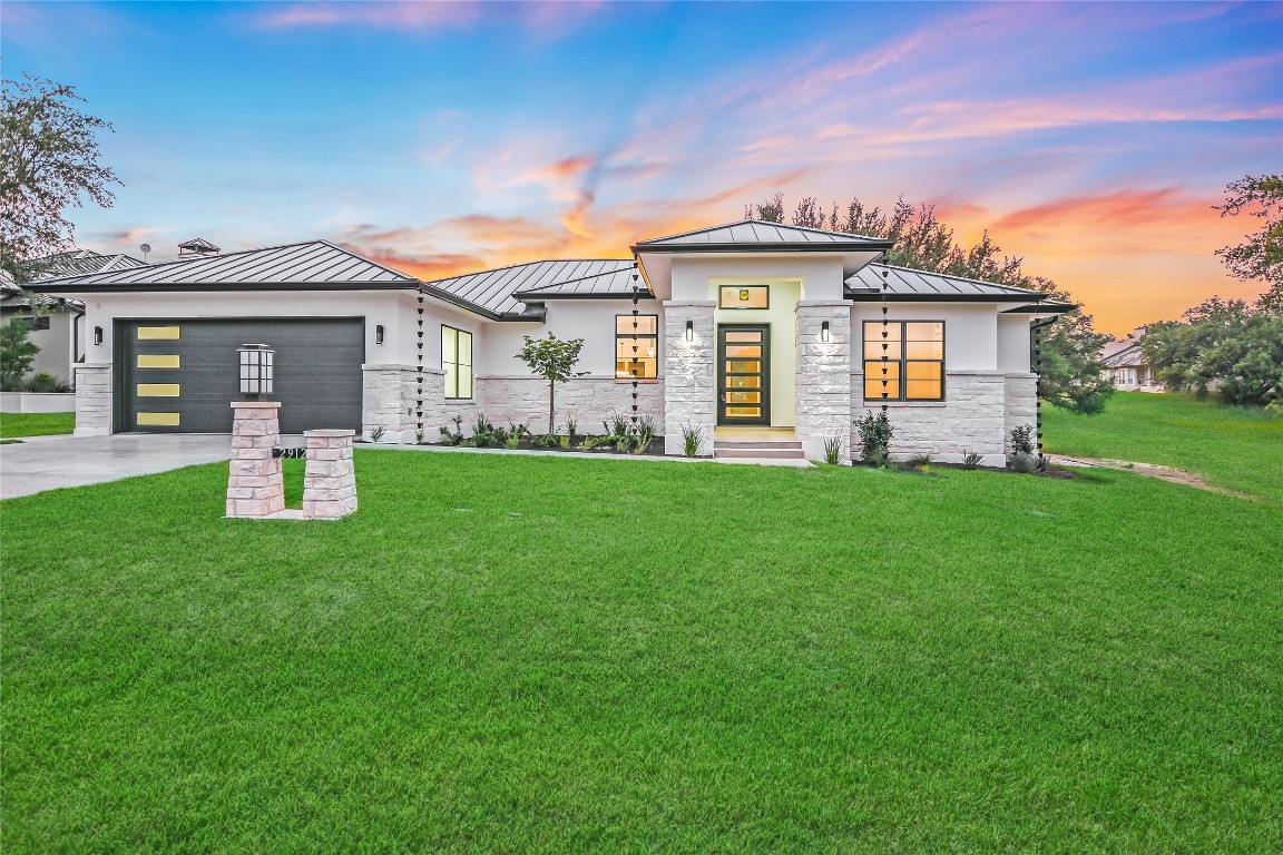 a front view of house with yard and green space