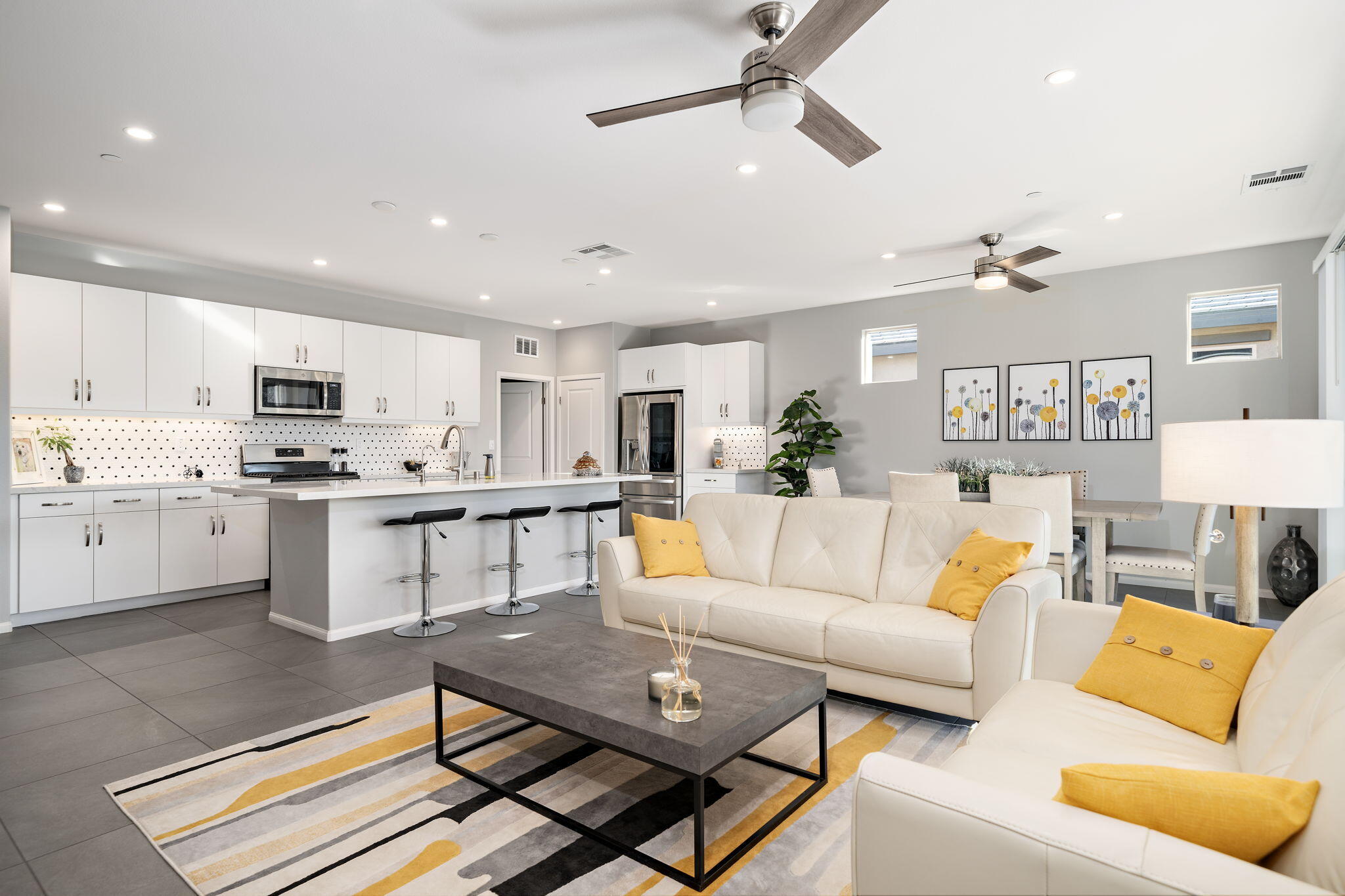 a living room with furniture and kitchen view