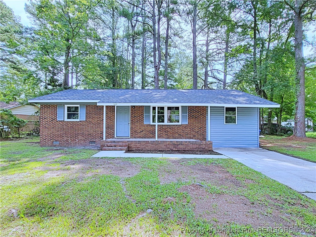 front view of a house and a yard with trees