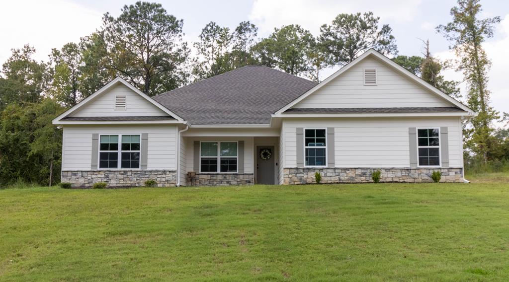 a front view of house with a garden