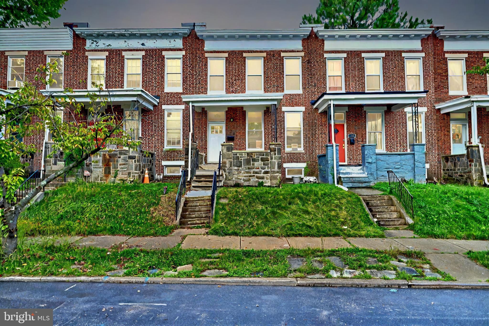 front view of a brick house with a yard