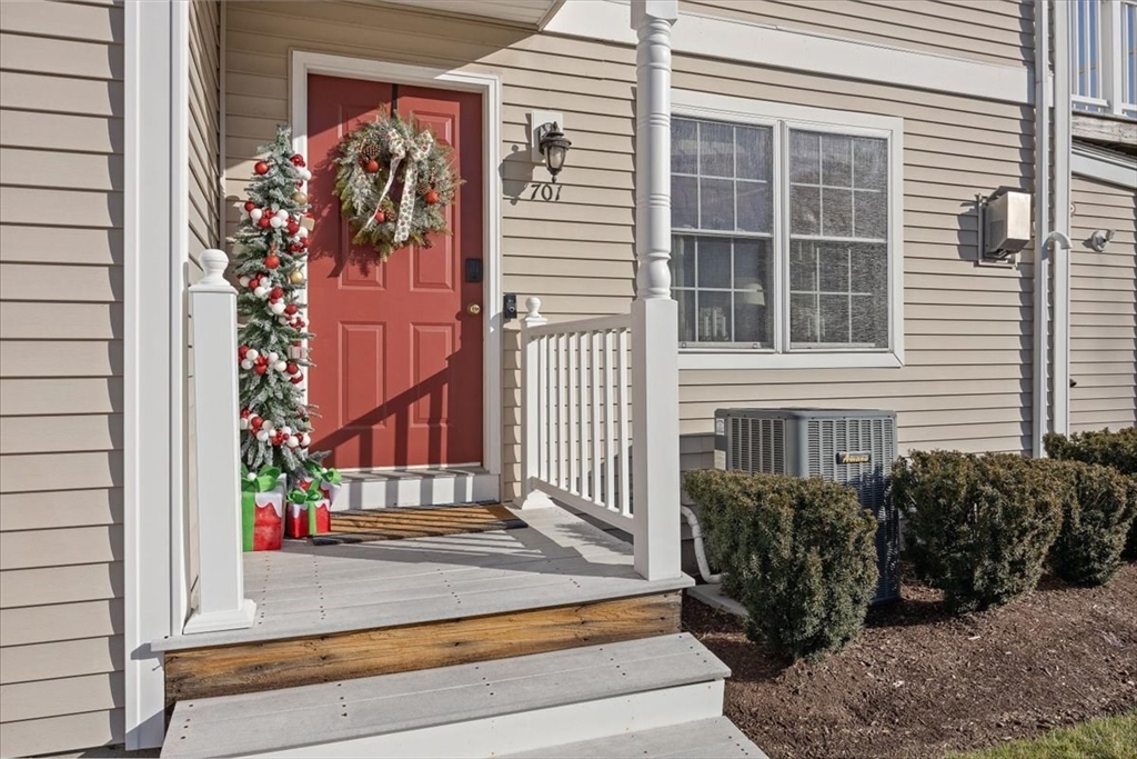 a view of front door of house with potted plants