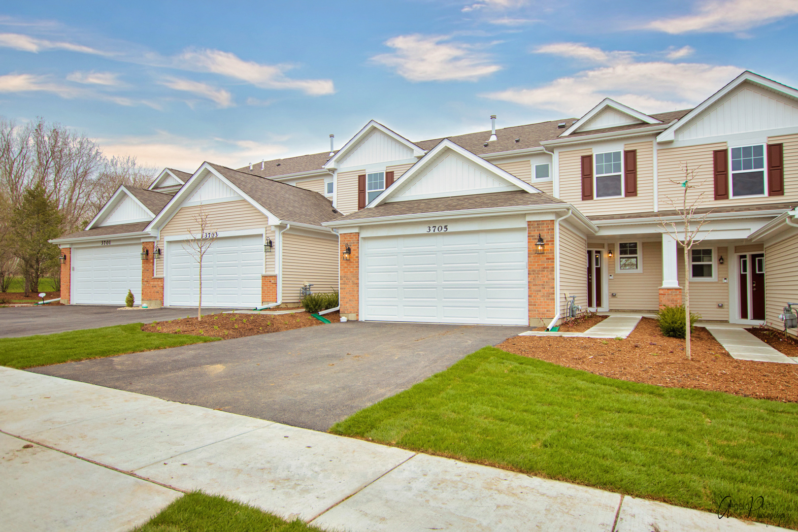 a front view of a house with a garden and yard