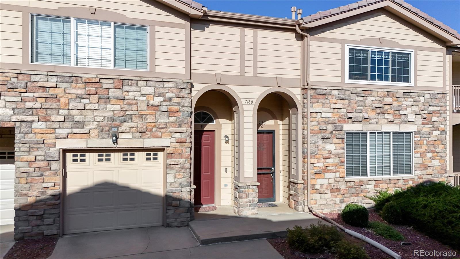 a front view of a house with a garage