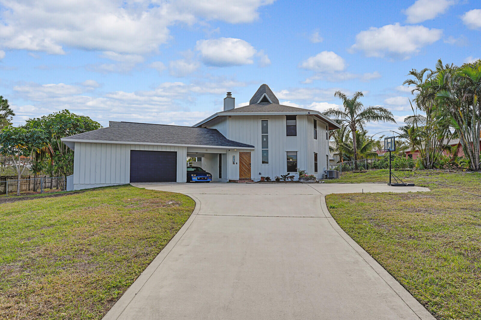 a front view of a house with a yard and trees