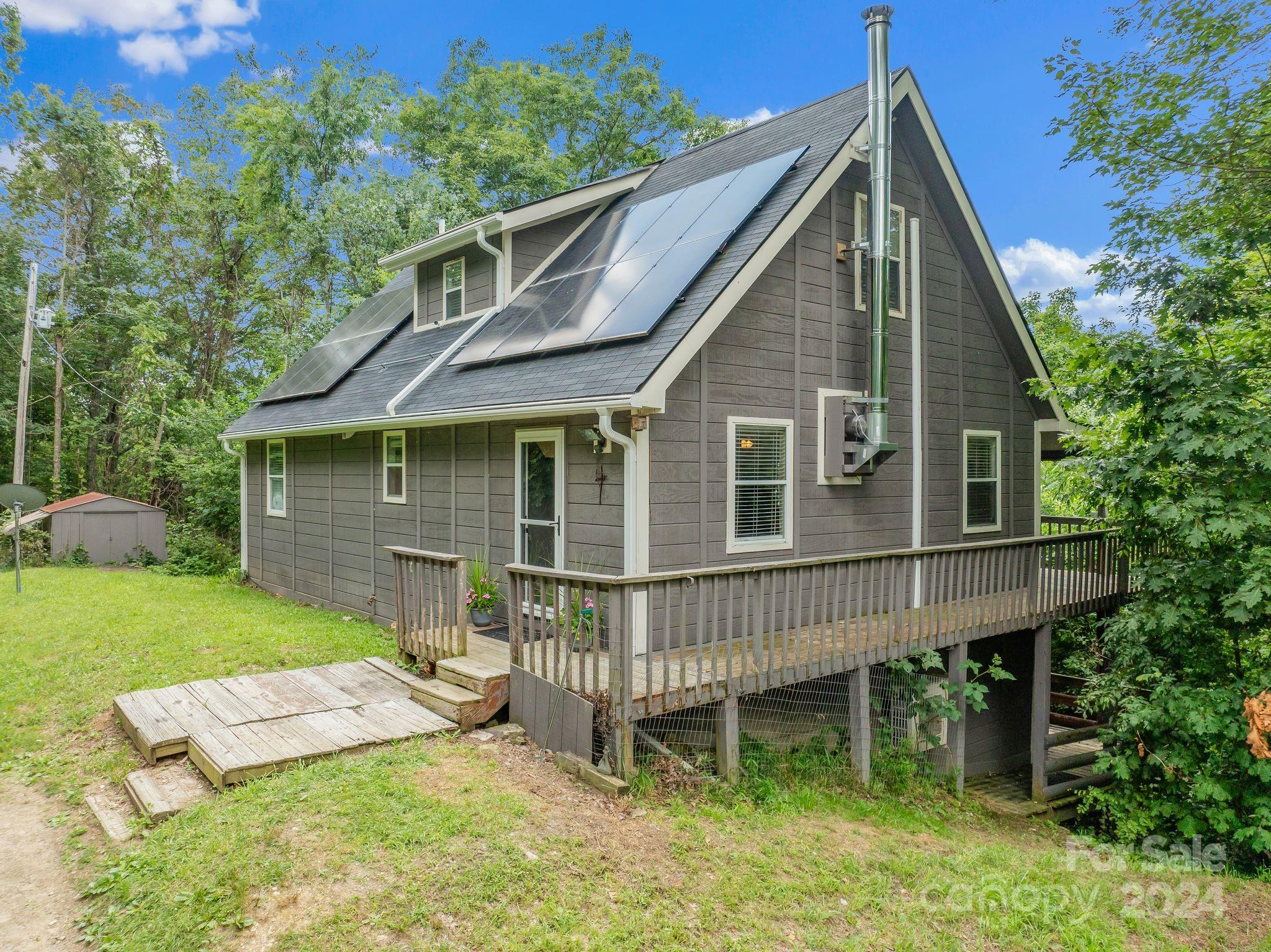 a view of a house with a yard and deck