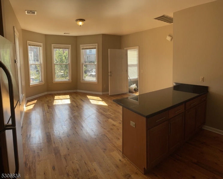 a view of a sink a window and wooden floor