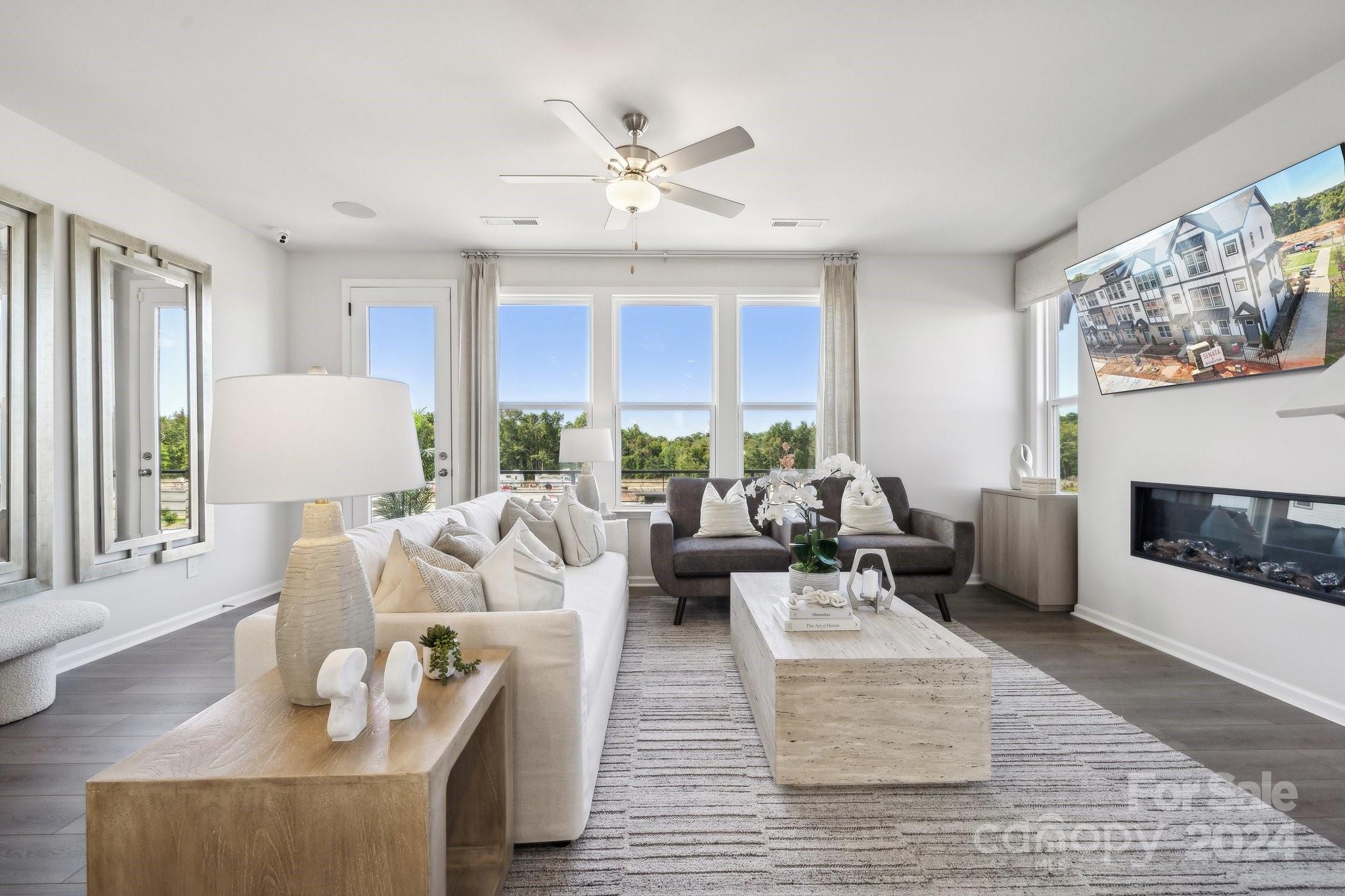 a living room with furniture fireplace and window