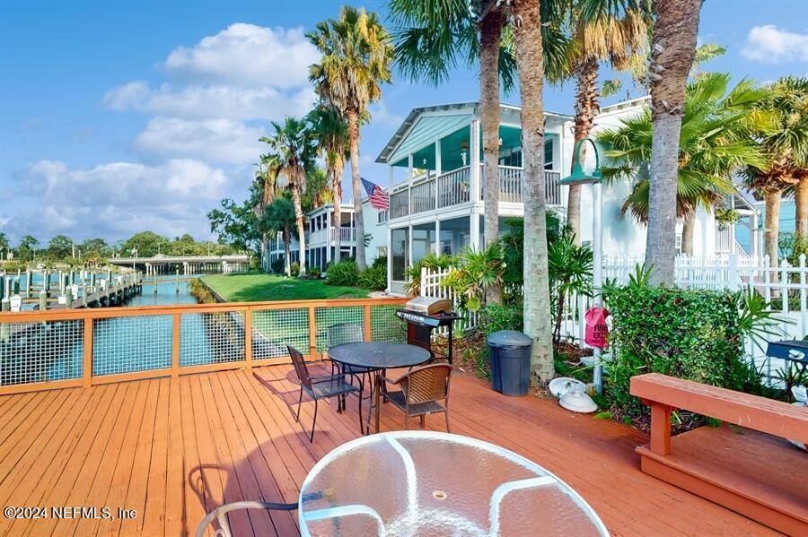 a view of a chairs and table in patio with a lake view