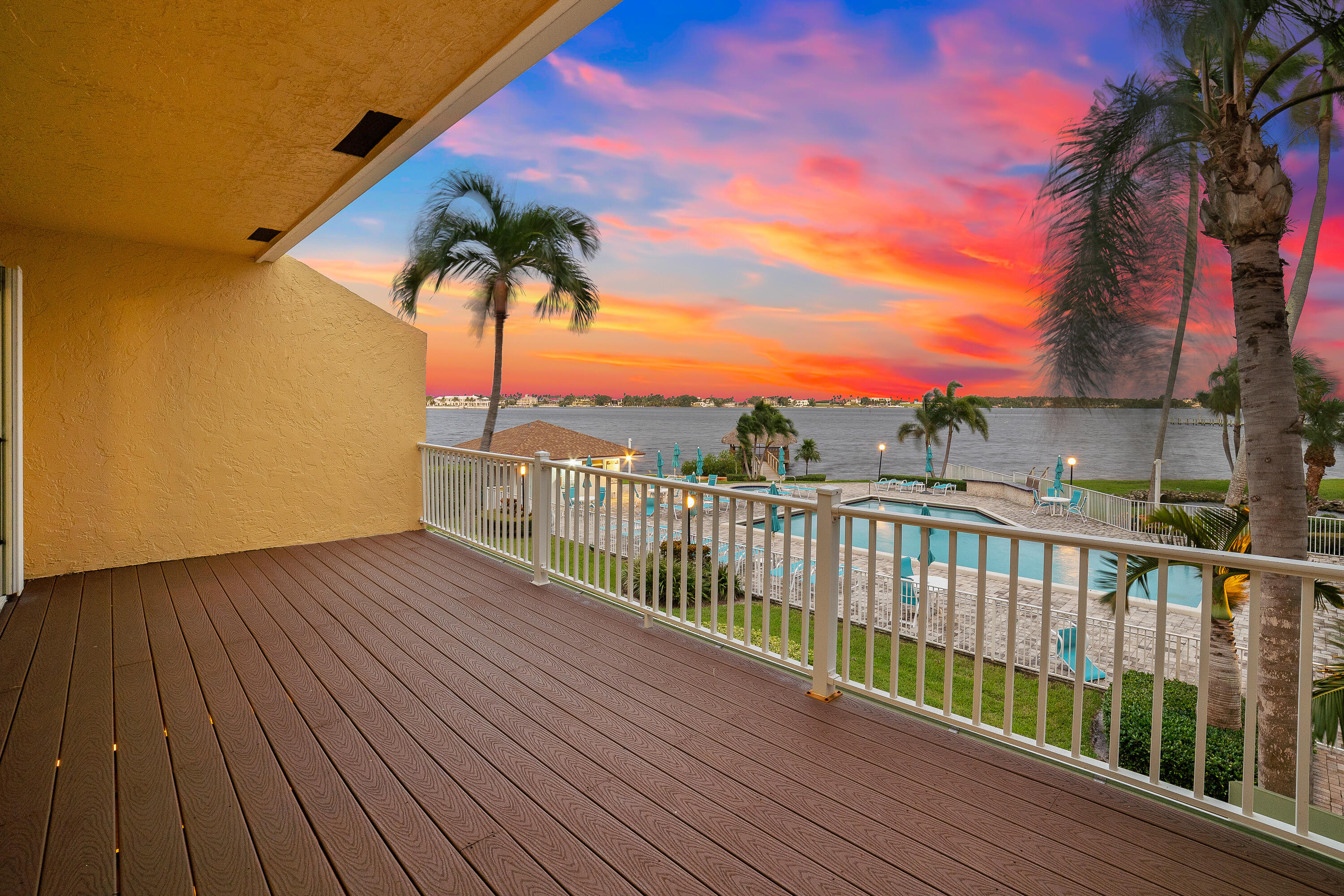 a view of balcony with wooden floor and fence