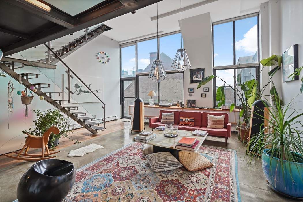 a living room with patio furniture and a potted plant