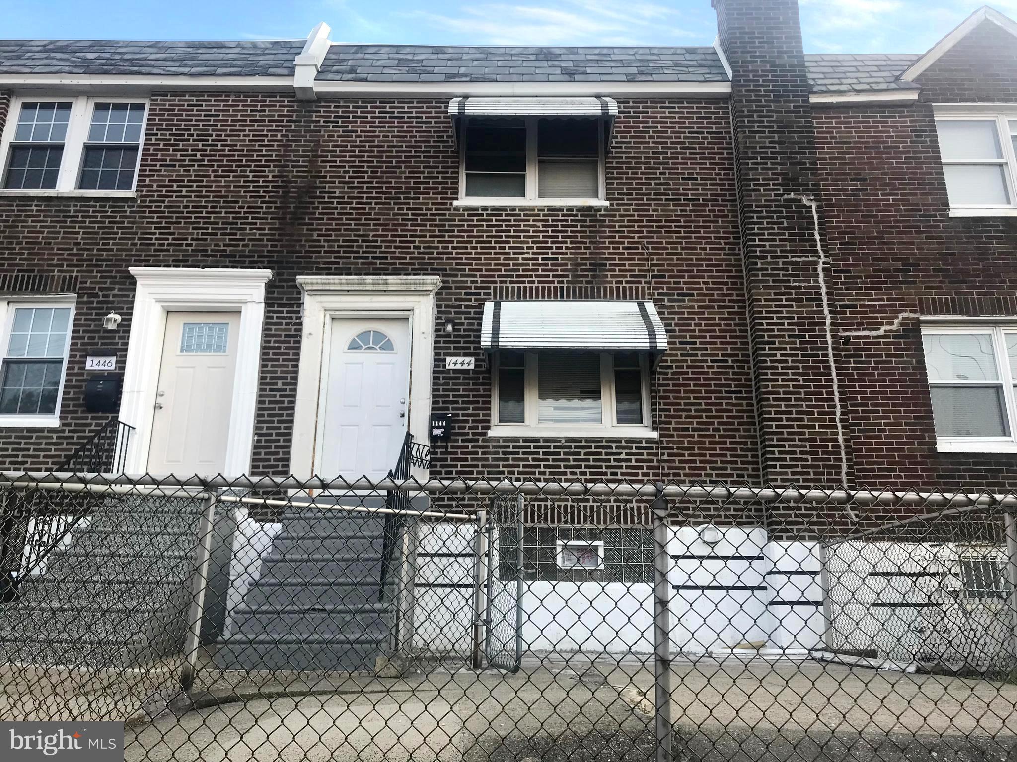 a front view of a house with stairs