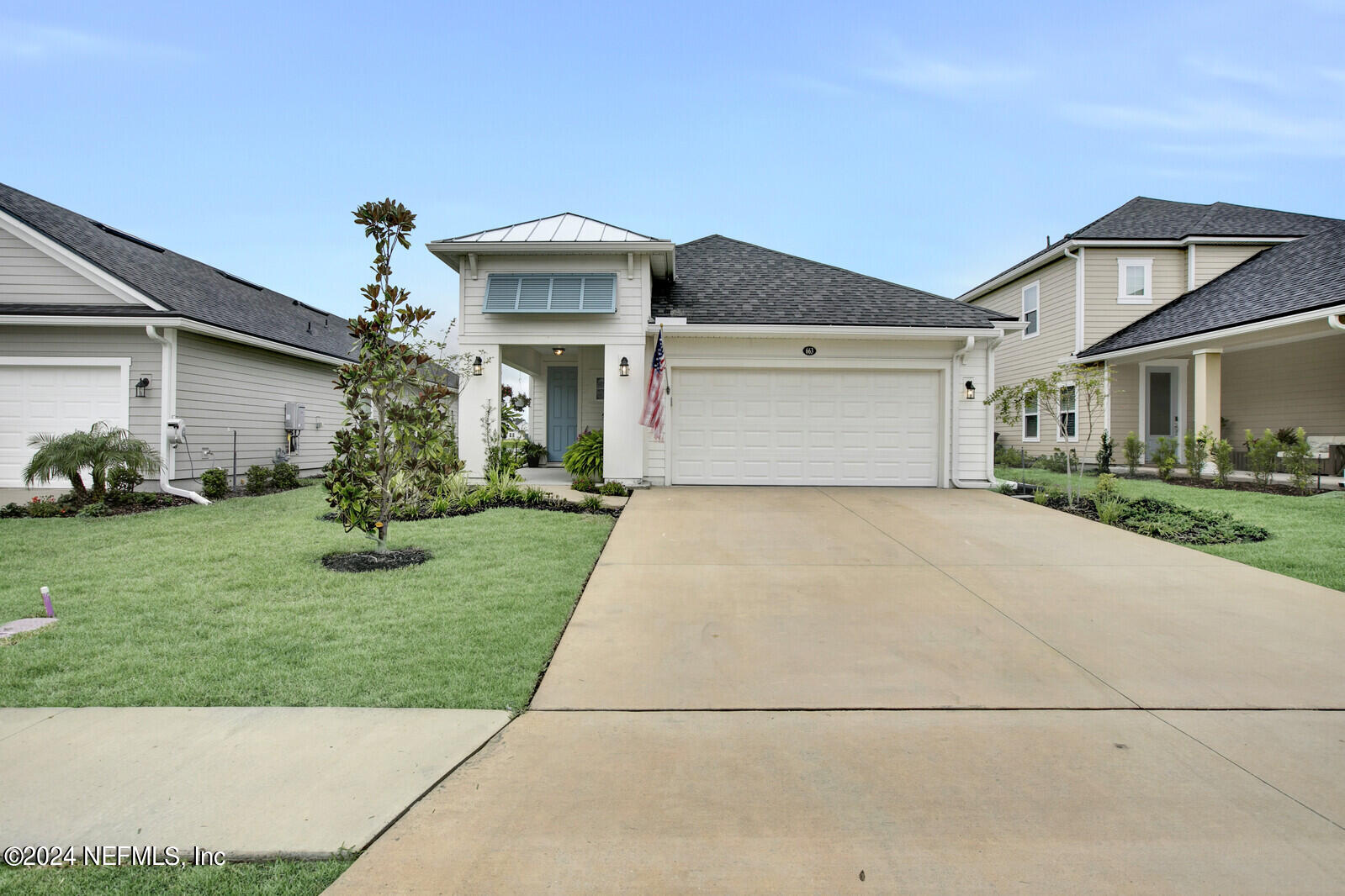 a front view of a house with a garden