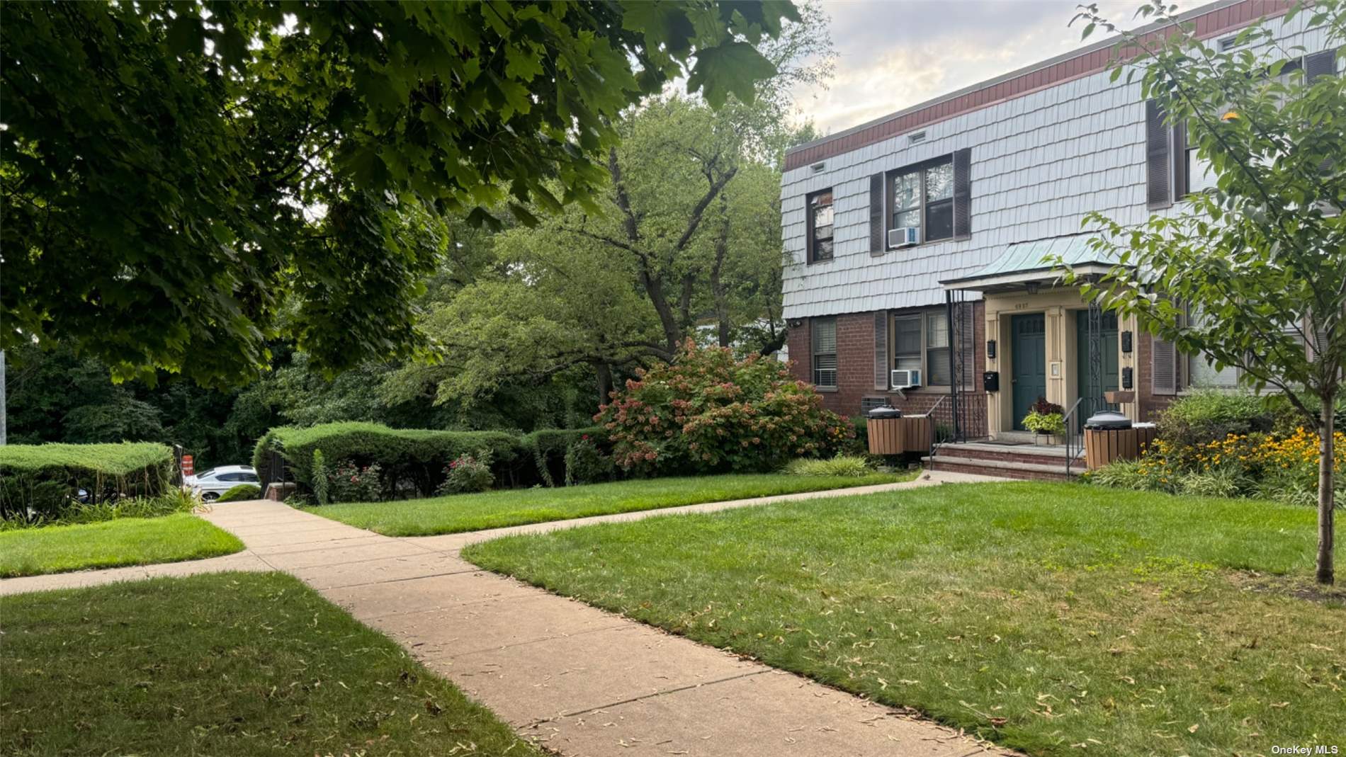 a view of a house with a yard and sitting area