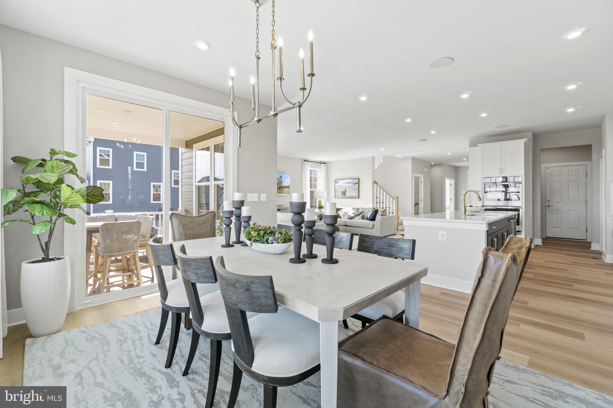 a dining room with furniture and wooden floor