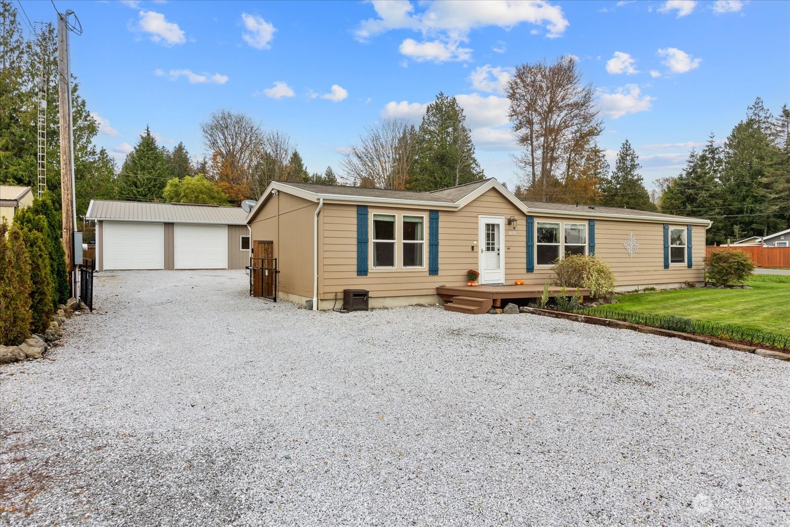 a view of a house with yard and a tree