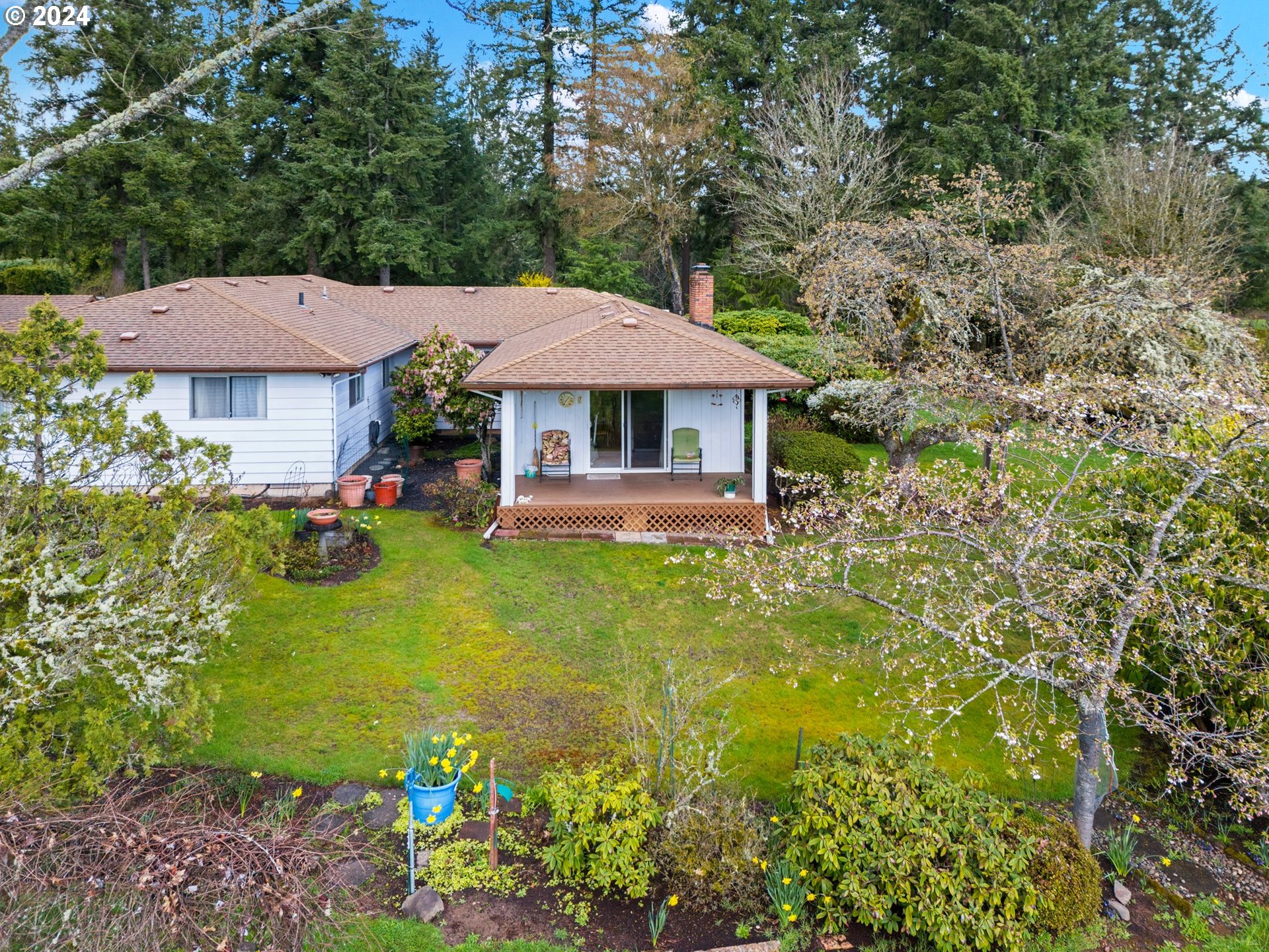 a view of a house with a yard garden and sitting area