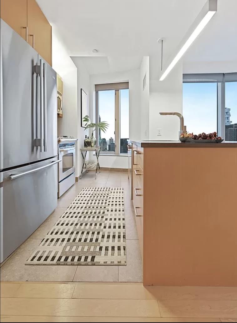 a living room with a couch and a refrigerator