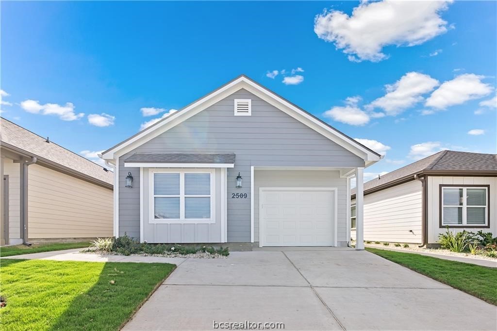 a front view of a house with a yard and garage