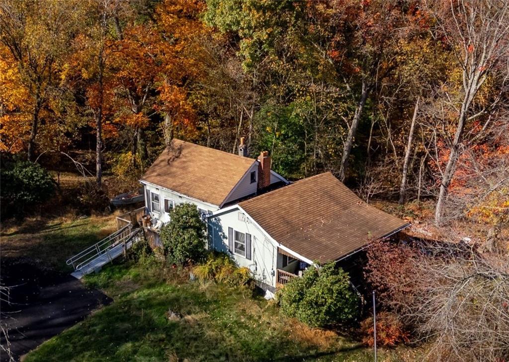 an aerial view of a house with yard and outdoor seating