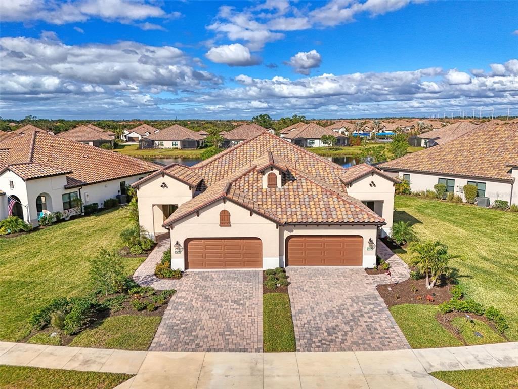 an aerial view of a house with a yard