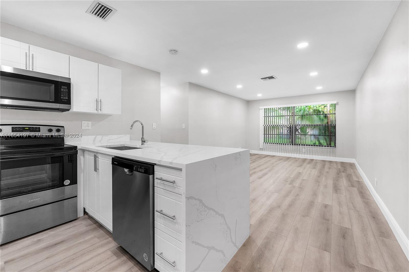 a kitchen with a sink stove and microwave