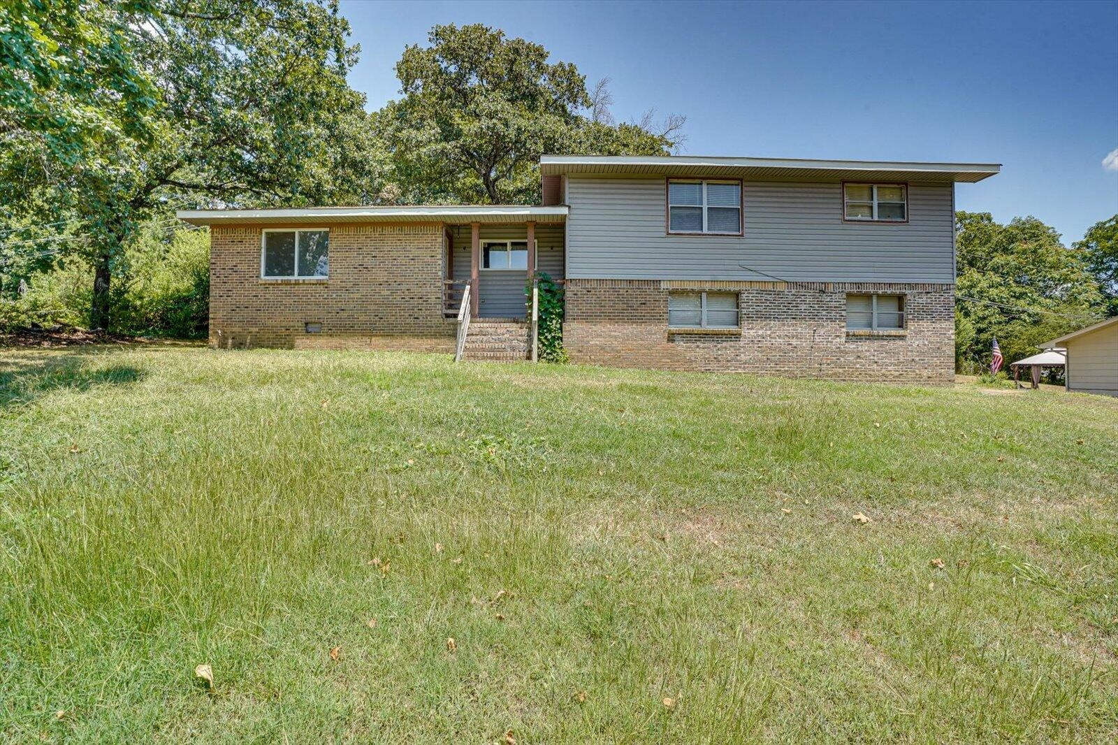 a front view of house with yard and trees