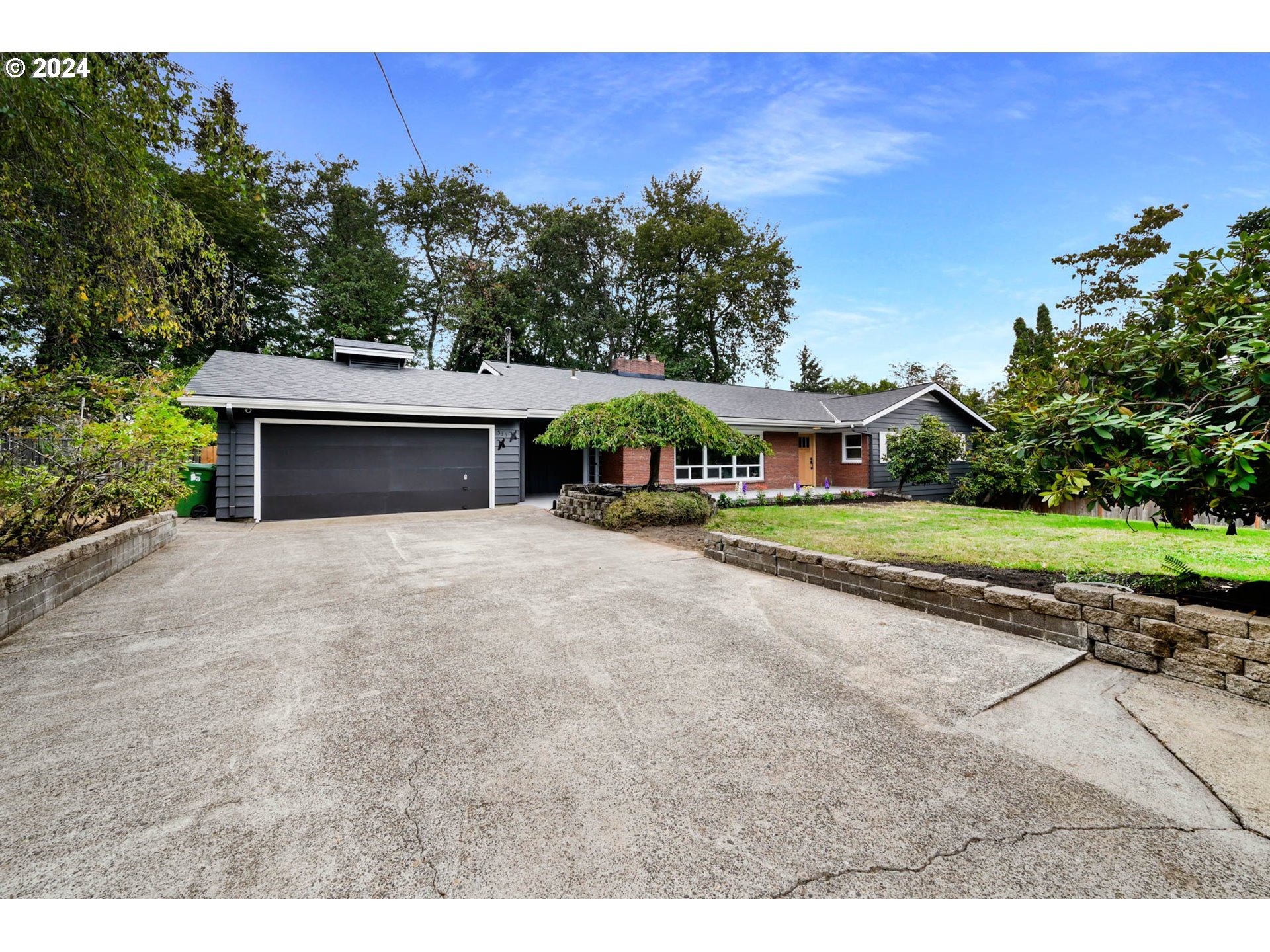 a front view of a house with a yard and a garage