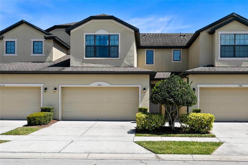 a front view of a house with a yard garage and outdoor seating