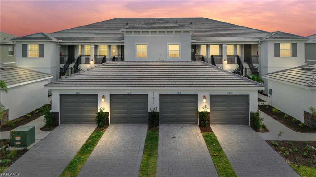 a front view of a house with a yard and a garage