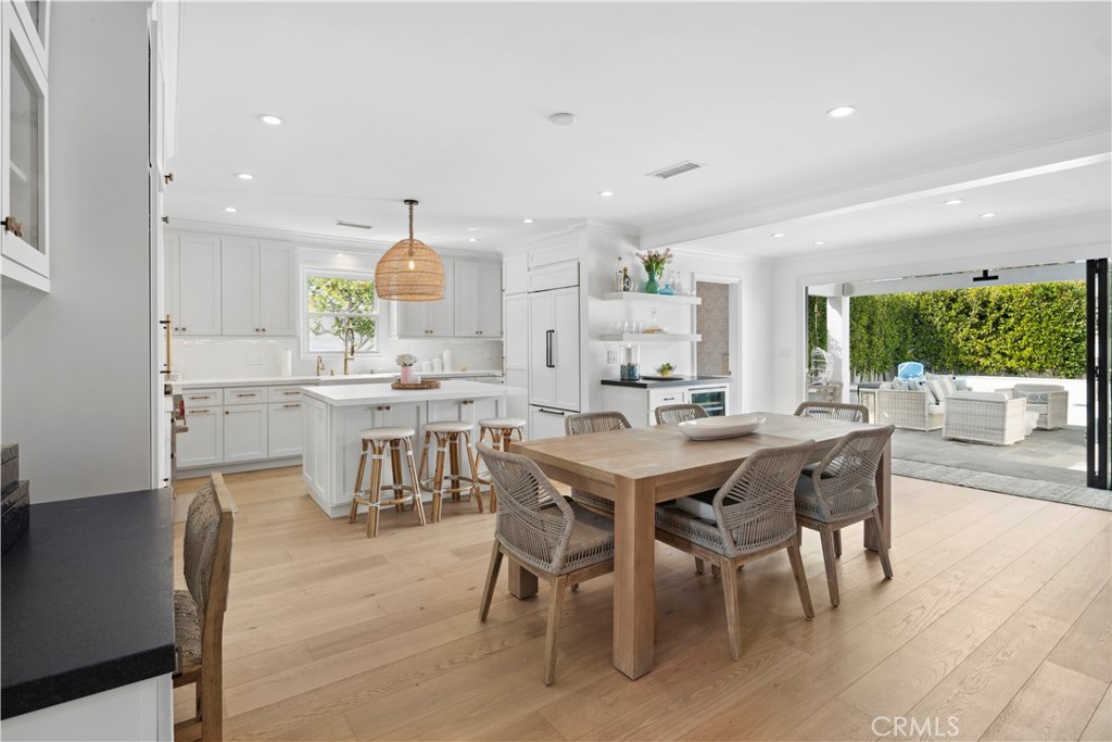 a dining area with furniture and a wooden floor