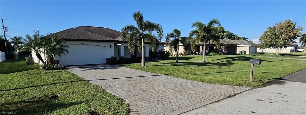 a front view of a house with a yard and potted plants