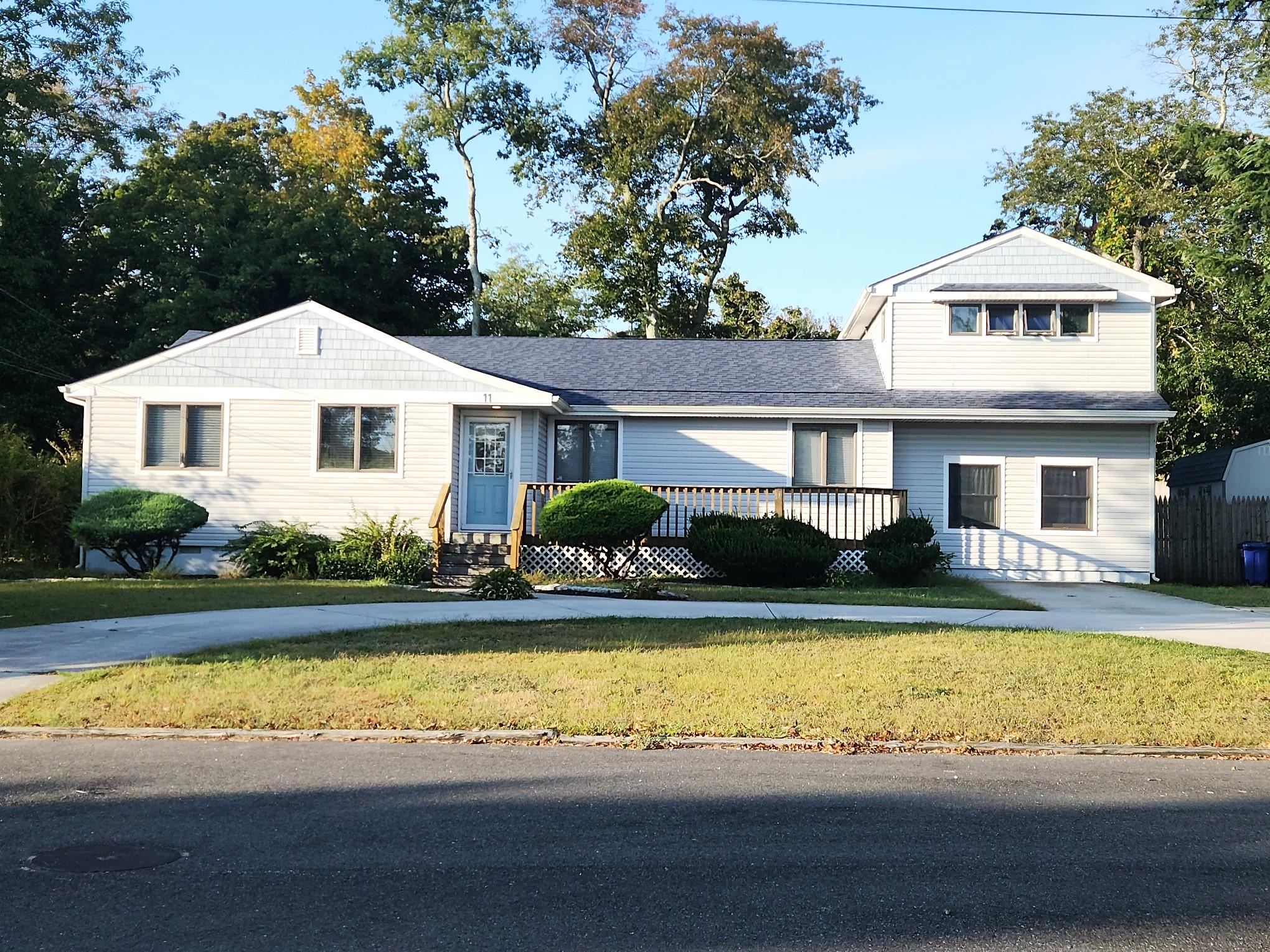 a front view of a house with a yard table and chairs