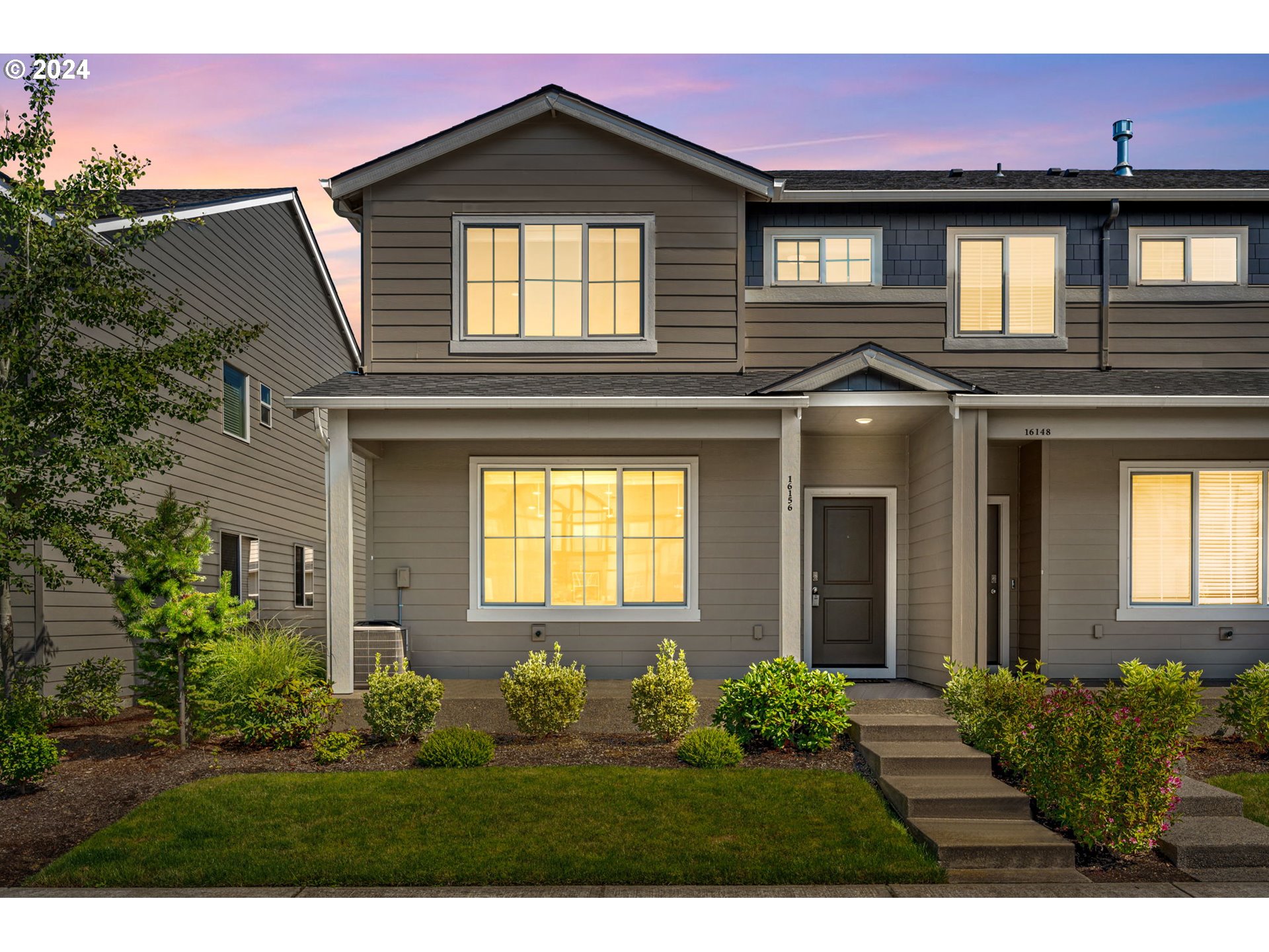 a front view of a house with a yard