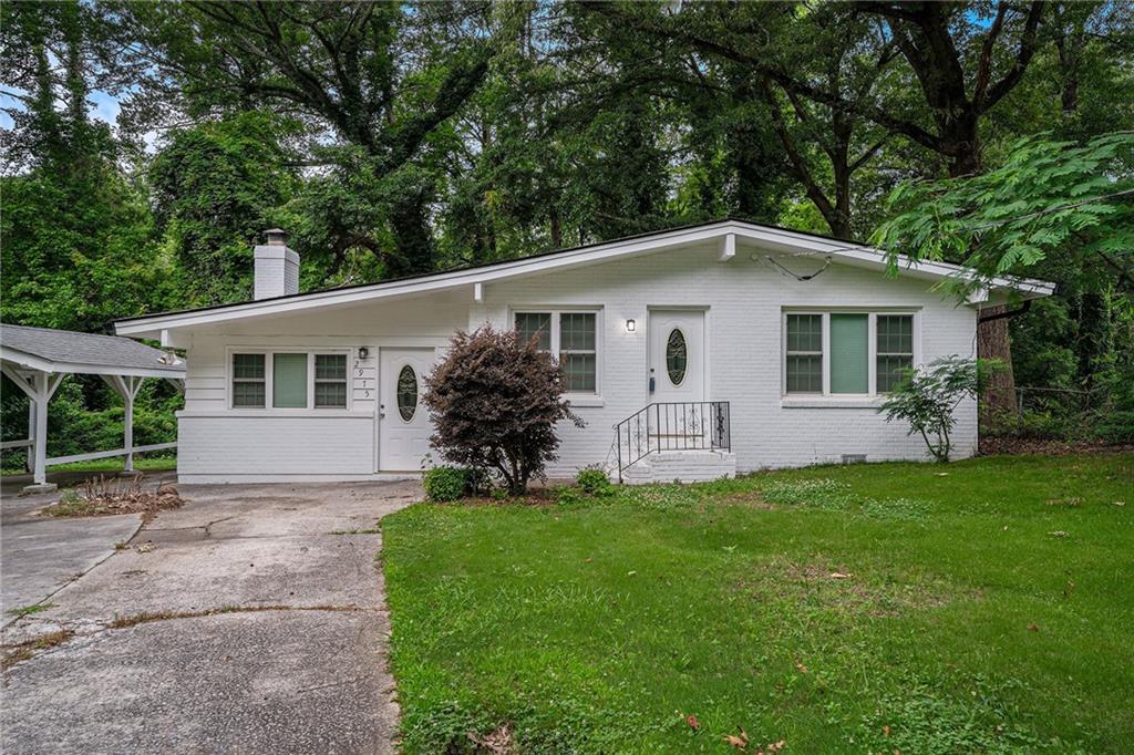 a front view of house with yard and green space